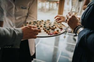 Guests at a Private Party take canapés and enjoy catering.